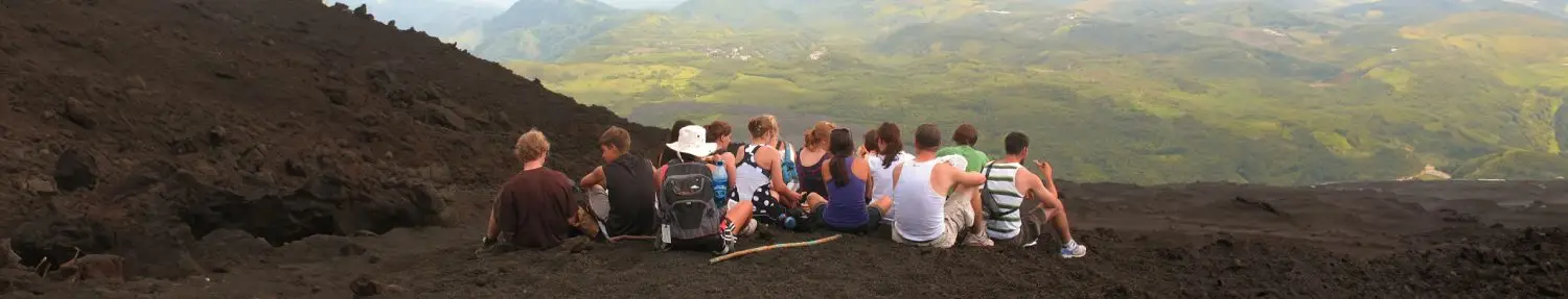 A group of young travelers in break on the Pacaya volcano. Guatemala Travel Blog